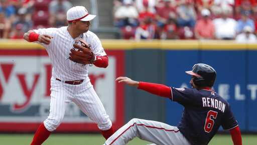 Cincinnati Reds shortstop Jose Iglesias, left, forces out Washington Nationals' Anthony Rendon (6) at second in the fourth inning of a baseball game, Sunday, June 2, 2019, in Cincinnati. (AP Photo/John Minchillo)