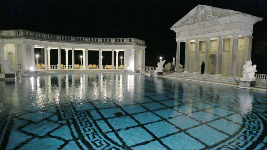 FILE - This Dec. 5, 2013, file photo, shows the Neptune Pool on the grounds of Hearst Castle, the former home of publishing magnate William Randolph Hearst, in San Simeon, Calif. Members of The Foundation at Hearst Castle will be among the few allowed to swim in the California landmark's iconic pools. Special fundraising events starting in July will allow members only to pay for a swim in the Neptune Pool on four dates this year and two other nights at the indoor Roman Pool. (AP Photo/Reed Saxon, File)