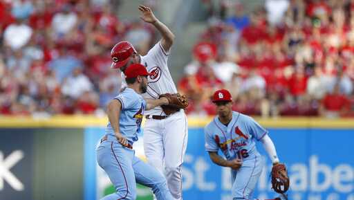 Cincinnati Reds'  Jesse Winker, center, is out on a double play ball off the bat of Joey Votto as St. Louis Cardinals shortstop Paul DeJong, left, makes the tag during the first inning of a baseball game, Saturday, July 20, 2019, in Cincinnati. (AP Photo/Gary Landers)