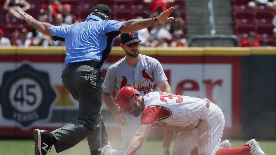 Cincinnati Reds' Jesse Winker (33) slides safely into second against St. Louis Cardinals shortstop Paul DeJong on a double off starting pitcher Jack Flaherty in the fifth inning of a baseball game, Sunday, July 21, 2019, in Cincinnati. (AP Photo/John Minchillo)