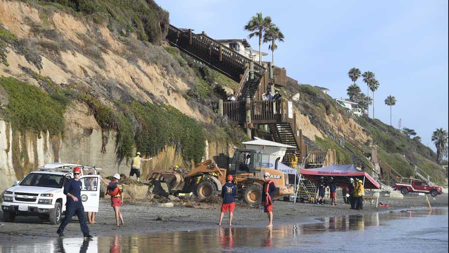 Search and rescue personnel work at the site of a cliff collapse at a popular beach Friday, Aug. 2, 2019, in Encinitas, Calif. At least one person was reportedly killed, and multiple people were injured, when an oceanfront bluff collapsed Friday at Grandview Beach in the Leucadia area of Encinitas, authorities said.(AP Photo/Denis Poroy)
