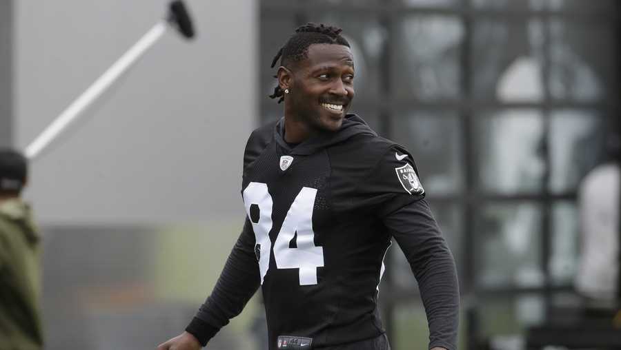 FILE - In this Aug. 20, 2019 file photo, Oakland Raiders' Antonio Brown smiles before stretching during NFL football practice in Alameda, Calif.  Brown was released by the Raiders,  Saturday, Sept. 7, 2019.