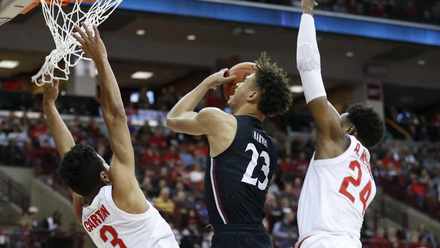 Cincinnati's Zach Harvey, center, tries to shoot between Ohio State's D.J. Carton, left, and Andre Wesson during the first half of an NCAA college basketball game Wednesday, Nov. 6, 2019, in Columbus, Ohio. (AP Photo/Jay LaPrete)