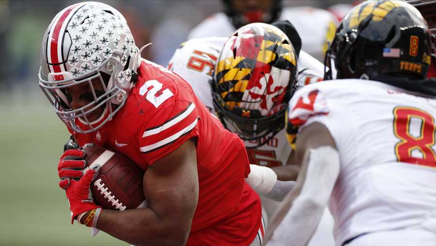 Ohio State running back J.K. Dobbins, left, breaks through the line of scrimmage to score a touchdown against Maryland during the first half of an NCAA college football game Saturday, Nov. 9, 2019, in Columbus, Ohio. (AP Photo/Jay LaPrete)