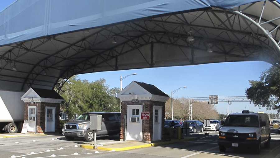 FILE- In this Jan. 29, 2016 file photo shows the entrance to the Naval Air Base Station in Pensacola, Fla. The US Navy is confirming that an active shooter and one other person are dead after gunfire at the Naval Air Station in Pensacola. Area hospital representatives tell The Associated Press that at least 11 people were hospitalized. The base remains locked down amid a huge law enforcement response. (AP Photo/Melissa Nelson, File)