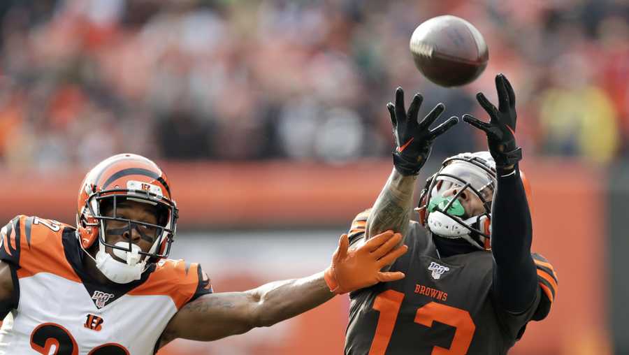 Cleveland Browns wide receiver Odell Beckham Jr. (13) can't hold onto the ball under pressure from Cincinnati Bengals cornerback William Jackson (22) during the first half of an NFL football game, Sunday, Dec. 8, 2019, in Cleveland. (AP Photo/Ron Schwane)