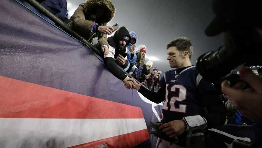 New England Patriots quarterback Tom Brady shakes hands with a fan as he leaves the field after losing an NFL wild-card playoff football game to the Tennessee Titans, Saturday, Jan. 4, 2020, in Foxborough, Mass.
