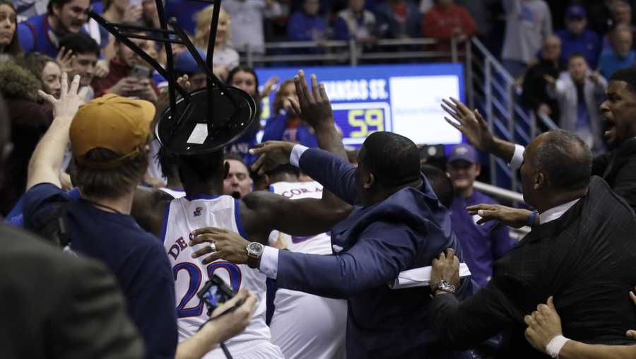 A fight between players spills into the crowd during the second half of an NCAA college basketball game between Kansas and Kansas State in Lawrence, Kan., Tuesday, Jan. 21, 2020. Kansas defeated Kansas State 81-59.