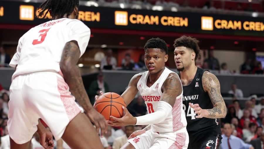 Houston guard Marcus Sasser (0) looks to pass the ball to guard DeJon Jarreau (3) under pressure from Cincinnati Bearcats guard Jarron Cumberland, right, during the first half of an NCAA college basketball game Sunday, March 1, 2020, in Houston. (AP Photo/Michael Wyke)
