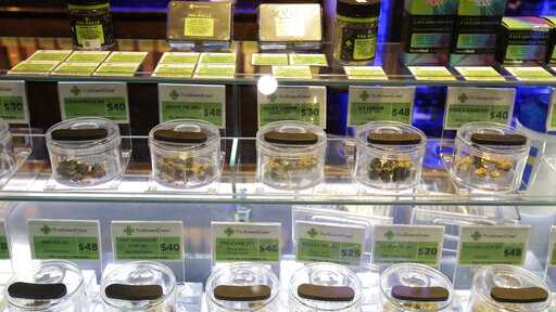 Various marijuana buds for sale are displayed at The Green Cross cannabis dispensary in San Francisco, Wednesday, March 18, 2020. As about 7 million people in the San Francisco Bay Area are under shelter-in-place orders, only allowed to leave their homes for crucial needs in an attempt to slow virus spread, marijuana stores remain open and are being considered "essential services." (AP Photo/Jeff Chiu)
