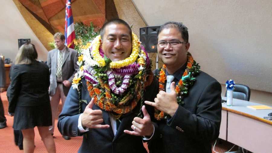 FILE - In this May 5, 2016 file photo, former Hawaii Rep. Derek Kawakami, left, and Rep. James Tokioka, right, both of Kauai, pose for photos in Honolulu. Kawakami has a choice word for a Florida man accused of trying to flout Hawaii’s traveler quarantine: "covidiot." He isn’t taking credit for coining the word borne out of the COVID-19 pandemic, but said, "I may be the first elected official to bust it out in public." (AP Photo/Cathy Bussewitz, File)