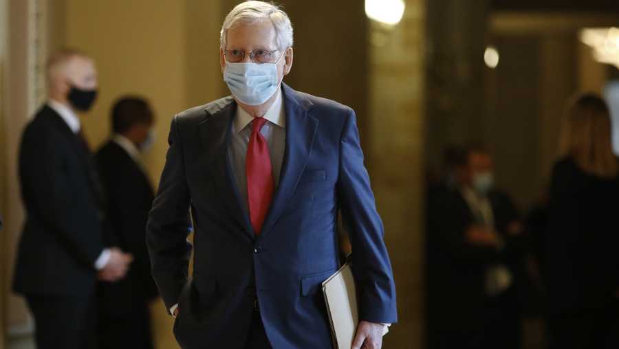 Senate Majority Leader Mitch McConnell of Ky., wears a face mask to protect against the spread of the new coronavirus as he walks to the Senate chamber after meeting with Vice President Mike Pence and Treasury Secretary Steve Mnuchin on Capitol Hill in Washington, Tuesday, May 19, 2020. (AP Photo/Patrick Semansky)