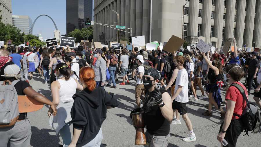 Protesters walk down Market Street toward the Gateway Arch, Monday, June 1, 2020, in St. Louis. Protesters gathered to speak out against the death of George Floyd who died after being restrained by Minneapolis police officers on May 25. (AP Photo/Jeff Roberson)