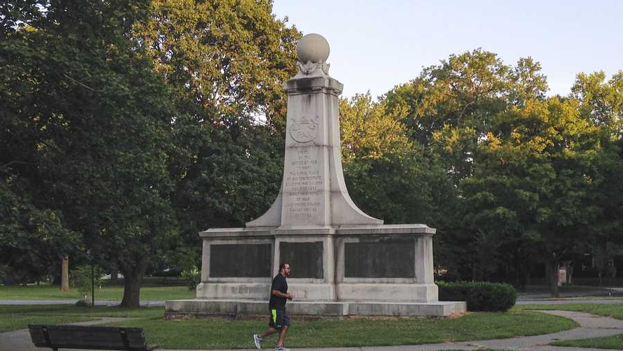 File-In this Aug. 15, 2017, file photo, a man runs in Garfield Park of Indianapolis past a monument dedicated to Confederate soldiers who died at a Union prison camp in the city during the Civil War. Mayor Joe Hogsett announced Thursday that the monument would be removed, calling it "a painful reminder of our state&apos;s horrific embrace of the Ku Klux Klan a century ago." (AP Photo/Tom Davies, File)