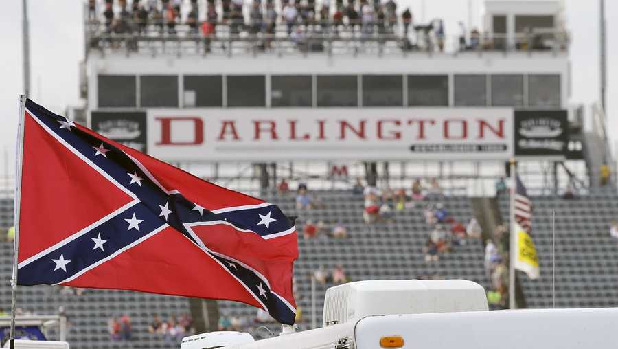 FILE - In this Sept. 5, 2015, file photo, a Confederate flag flies in the infield before a NASCAR Xfinity auto race at Darlington Raceway in Darlington, S.C. Bubba Wallace, the only African-American driver in the top tier of NASCAR, calls for a ban on the Confederate flag in the sport that is deeply rooted in the South. (AP Photo/Terry Renna, File)