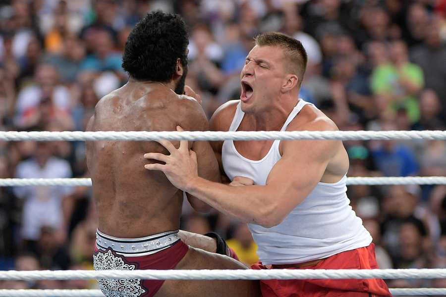New England Patriots tight end Rob Gronkowski delivers a body tackle to WWE Superstar Jinder Mahal during a match at WrestleMania 33 on Sunday, April 2, 2017, in Orlando, Fla.