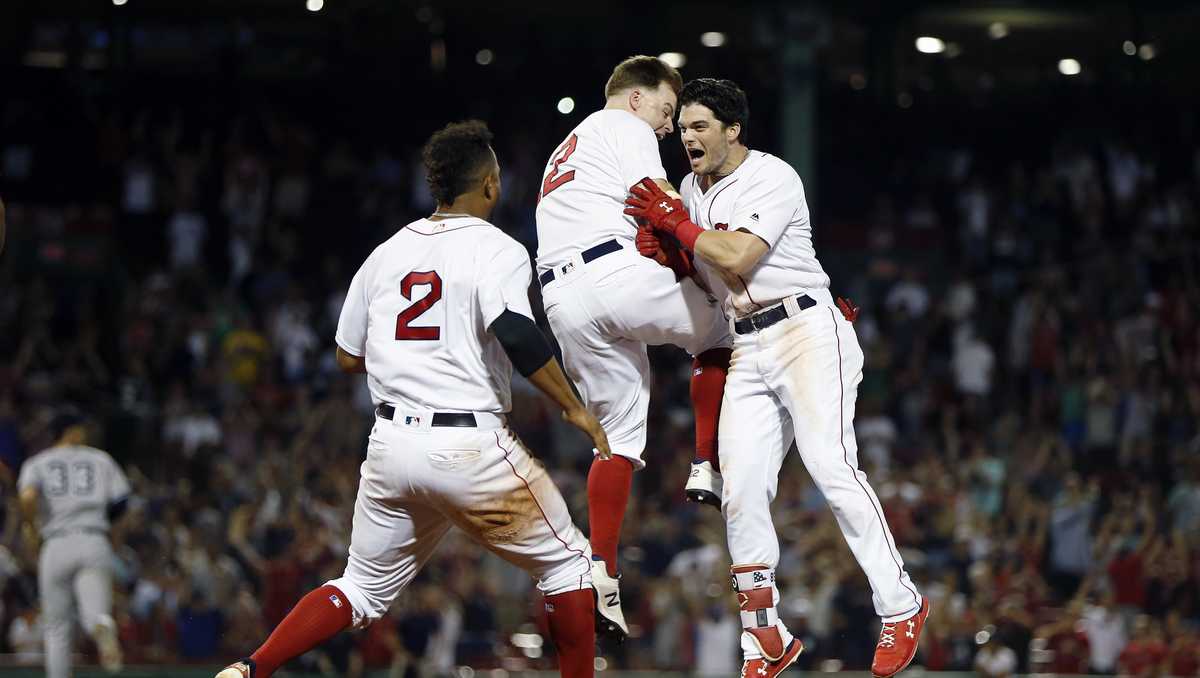 Xander Bogaerts and Brock Holt of the Boston Red Sox celebrate after