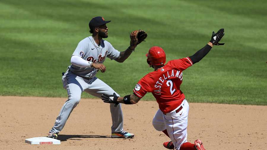 Cincinnati Reds&apos; Nicholas Castellanos (2) slides into a force out against Detroit Tigers&apos; Niko Goodrum (28) at second base during a baseball game at Great American Ballpark in Cincinnati, Sunday, July 26, 2020. The Tigers won 3-2. (AP Photo/Aaron Doster)