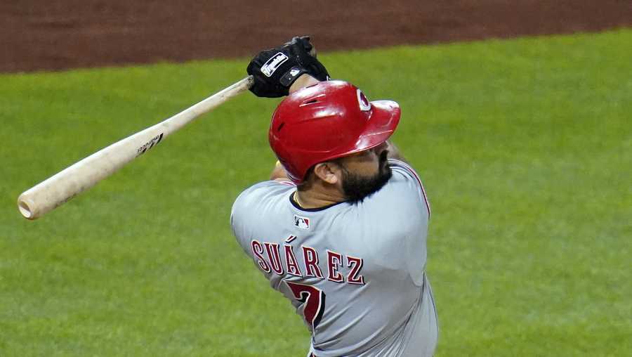 Cincinnati Reds&apos; Eugenio Suarez follows through on a solo home run, his third homer of the night, off Pittsburgh Pirates relief pitcher Derek Holland during the eighth inning of a baseball game in Pittsburgh, Saturday, Sept. 5, 2020. The Reds won 6-2. (AP Photo/Gene J. Puskar)