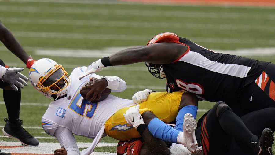 Los Angeles Chargers quarterback Tyrod Taylor (5) is sacked during the first half of an NFL football game against the Cincinnati Bengals, Sunday, Sept. 13, 2020, in Cincinnati. (AP Photo/Bryan Woolston)
