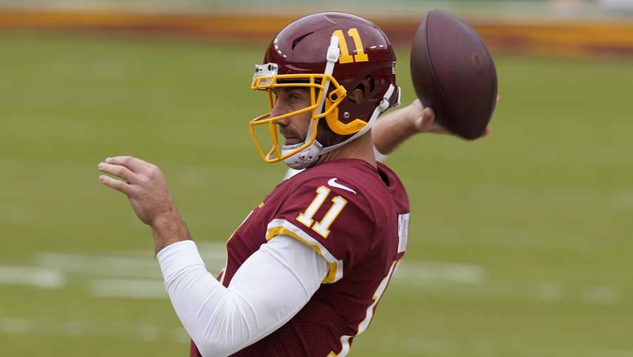Washington Football Team quarterback Alex Smith throws before an NFL football game against the Los Angeles Rams Sunday, Oct. 11, 2020, in Landover, Md. (AP Photo/Steve Helber)