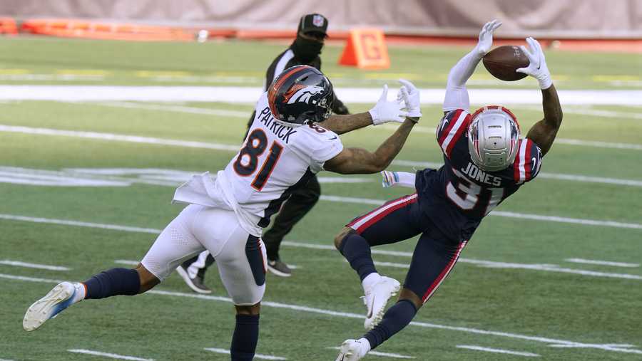 New England Patriots defensive back Jonathan Jones, right, intercepts a pass intended for Denver Broncos wide receiver Tim Patrick, left, in the second half of an NFL football game, Sunday, Oct. 18, 2020, in Foxborough, Mass. (AP Photo/Steven Senne)