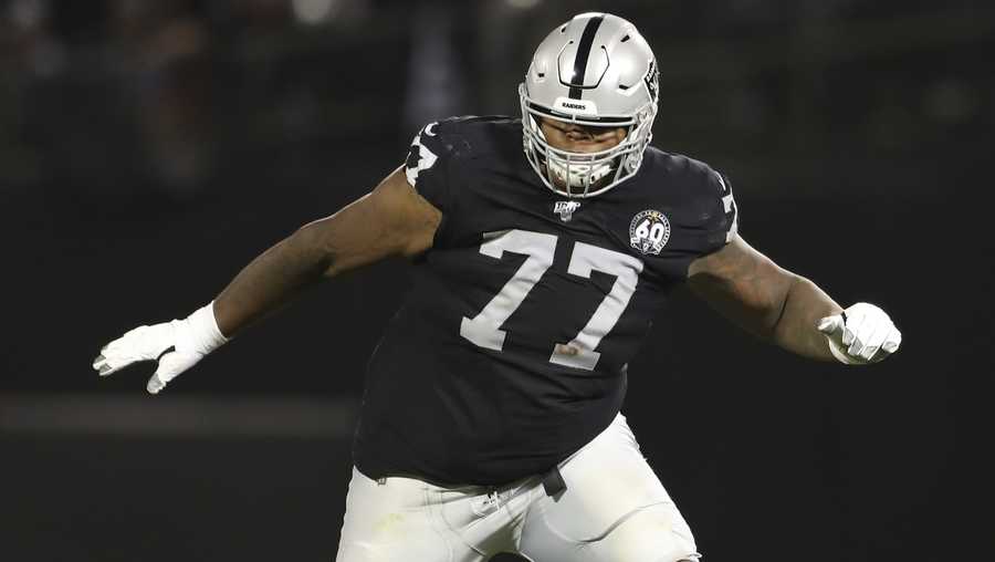 FILE - In this Sept. 9, 2019, file photo, Oakland Raiders offensive tackle Trent Brown (77) protects a gap in the offensive line during an NFL football game against the Denver Broncos, in Oakland, Calif. The Las Vegas Raiders sent all five starting offensive linemen home as part of coronavirus contact tracing after right tackle Trent Brown was placed on the reserve/COVID-19 list with a positive test. The Raiders held practice on Wednesday, Oct. 21, 2020 without their starting five as they prepare for Sunday’s home game against Tampa Bay.