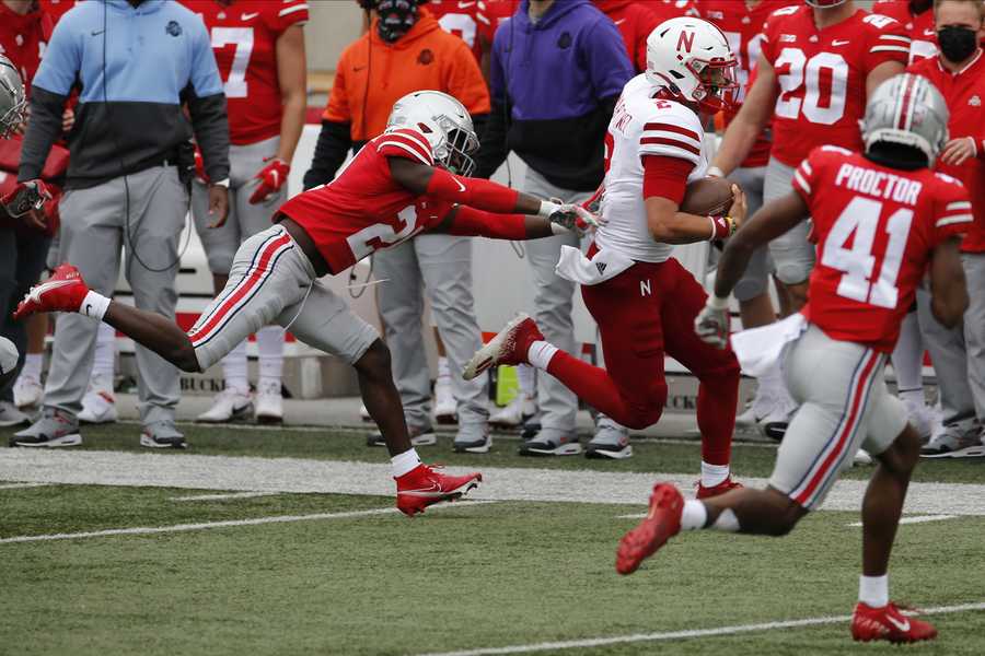 Ohio State defensive back Marcus Williamson, left, chases Nebraska quarterback Adrian Martinez during the second half of an NCAA college football game Saturday, Oct. 24, 2020, in Columbus, Ohio.  (AP Photo/Jay LaPrete)