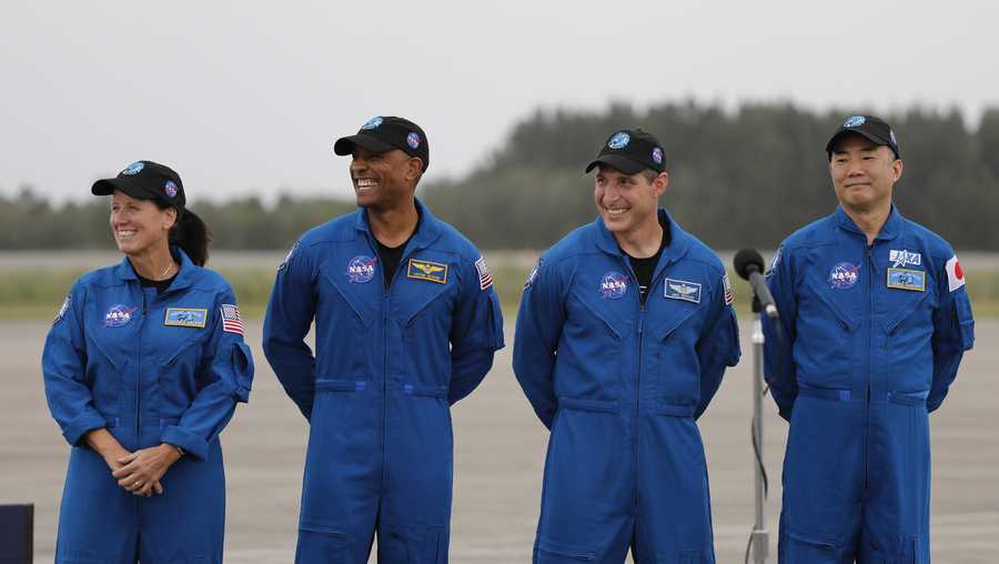 NASA Astronauts from left Shannon Walker, Victor Glover, Michael Hopkins and Japan Aerospace Exploration Agency Astronaut Soichi Noguchi smile during a news conference after they arrived at the Kennedy Space Center, Sunday, Nov. 8, 2020, in Cape Canaveral, Fla. The four astronauts will fly on the SpaceX Crew-1 mission to the International Space Station scheduled for launch on Nov. 14, 2020 (AP Photo/Terry Renna)