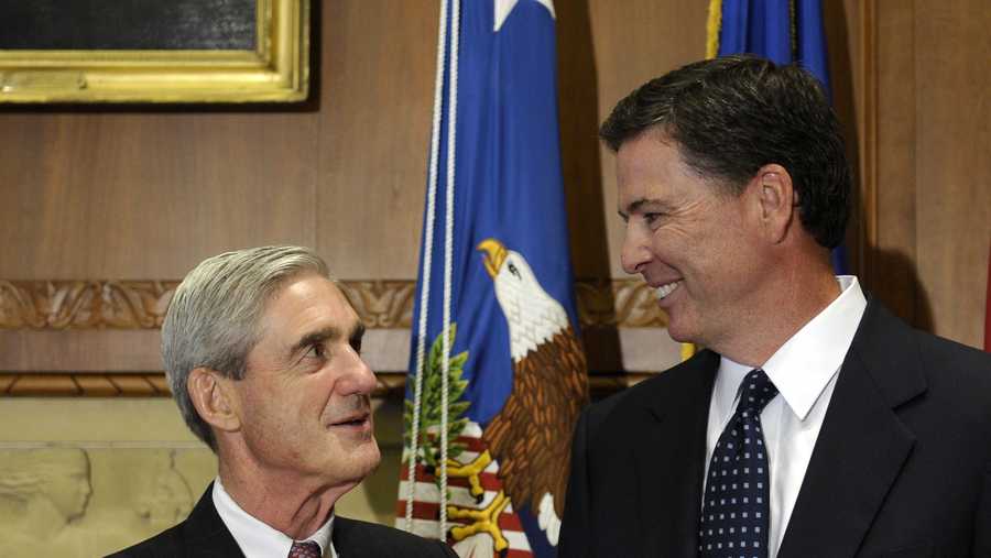 Then-incoming FBI Director James Comey talks with outgoing FBI Director Robert Mueller before Comey was officially sworn in at the Justice Department in Washington, Wednesday, Sept. 4, 2013.