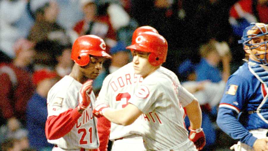 Cincinnati Reds' Bret Boone is greeted at the plate by teammates Tony Fernandez, left, and Brian Dorsett after Boone's two-run homer in the third inning in Chicago, May 2, 1994. Chicago Cubs catcher Mark Parent, right, looks on. It was the Cubs' 11th straight loss at home, a club record. The Cubs even tried a change of uniform to break the streak. (AP Photo/Fred Jewell)
