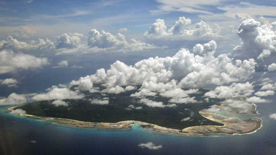 In this Nov. 14, 2005 file photo, clouds hang over the North Sentinel Island, in India's southeastern Andaman and Nicobar Islands. India used heat sensors on flights over hundreds of uninhabited Andaman Sea islands Friday, March 14, 2014, and will expand its search for the missing Malaysia Airlines jet farther west into the Bay of Bengal, officials said. The Indian-controlled archipelago that stretches south of Myanmar contains 572 islands covering an area of 720-by-52 kilometers. Only 37 are inhabited, with the rest covered in dense forests.