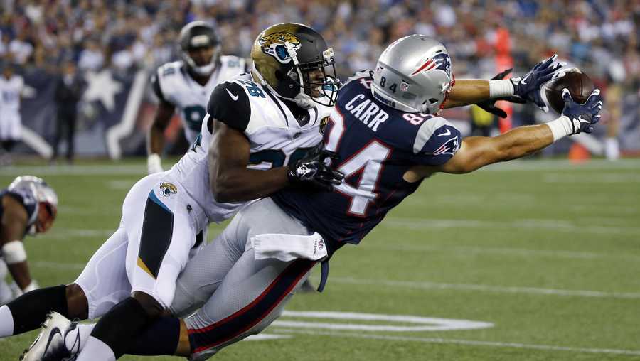 New England Patriots wide receiver Austin Carr (84) stretches for a catch in front of Jacksonville Jaguars cornerback Doran Grant (26) in the second half of an NFL preseason football game, Thursday, Aug. 10, 2017, in Foxborough, Mass. 