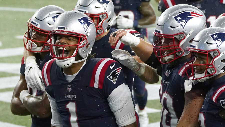 New England Patriots quarterback Cam Newton, left, celebrates his rushing touchdown with teammates in the second half of an NFL football game against the Baltimore Ravens, Sunday, Nov. 15, 2020, in Foxborough, Mass. (AP Photo/Charles Krupa)