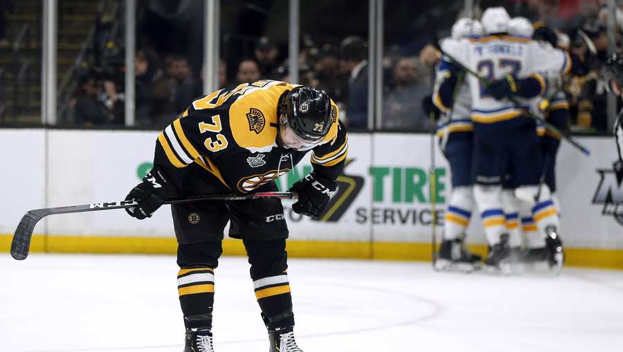 Boston Bruins' Charlie McAvoy reacts as the St. Louis Blues celebrate Brayden Schenn's goal, right, during the third period in Game 7 of the NHL hockey Stanley Cup Final, Wednesday, June 12, 2019, in Boston. (AP Photo/Michael Dwyer)