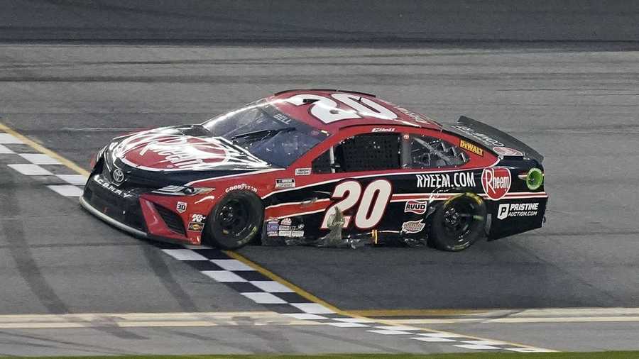 Christopher Bell crosses the finish line to win the NASCAR Cup Series road course auto race at Daytona International Speedway, Sunday, Feb. 21, 2021, in Daytona Beach, Fla. (AP Photo/John Raoux)
