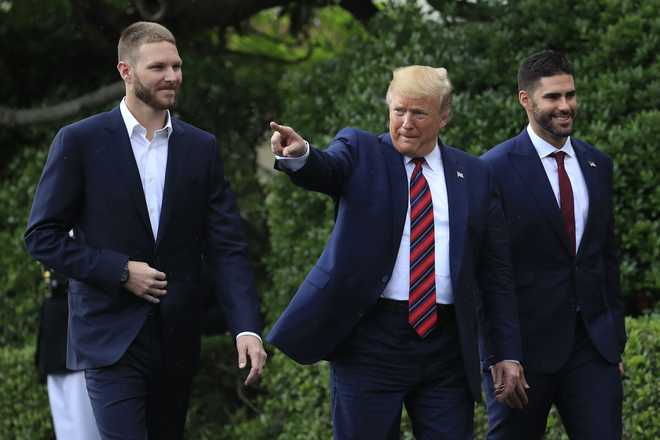 President Donald Trump shakes hands with Boston Red Sox outfielder J. D.  Martinez as he welcomes the 2018 World Series Champions Boston Red Sox,  during a ceremony honoring them at the White