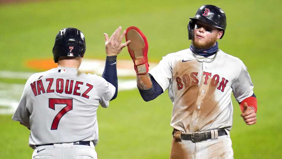 Boston Red Sox&apos;s Christian Vazquez (7) and Alex Verdugo react after scoring on a single by Michael Chavis during the sixth inning of a baseball game against the Baltimore Orioles, Friday, Aug. 21, 2020, in Baltimore. (AP Photo/Julio Cortez)