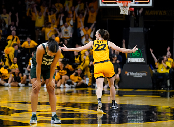 Iowa&#x20;guard&#x20;Caitlin&#x20;Clark,&#x20;right,&#x20;celebrates&#x20;in&#x20;front&#x20;of&#x20;Michigan&#x20;State&#x20;guard&#x20;Moira&#x20;Joiner,&#x20;left,&#x20;after&#x20;her&#x20;three-point&#x20;basket&#x20;at&#x20;the&#x20;end&#x20;of&#x20;an&#x20;NCAA&#x20;college&#x20;basketball&#x20;game,&#x20;Tuesday,&#x20;Jan.&#x20;2,&#x20;2024,&#x20;in&#x20;Iowa&#x20;City,&#x20;Iowa.&#x20;Iowa&#x20;won&#x20;76-73.