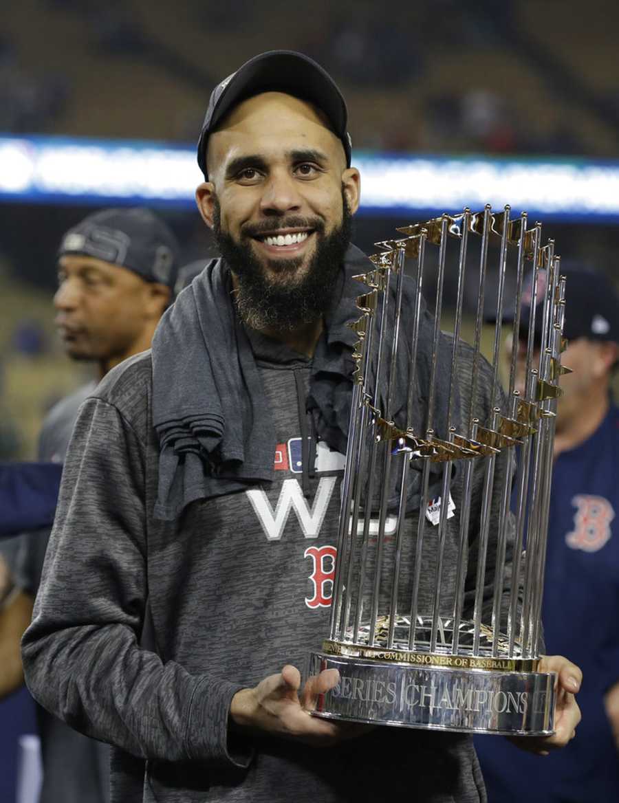 Boston Red Sox pitcher David Price holds the championship trophy after Game 5 of baseball's World Series against the Los Angeles Dodgers on Sunday, Oct. 28, 2018, in Los Angeles. The Red Sox won 5-1 to win the series 4 game to 1. (AP Photo/David J. Phillip)