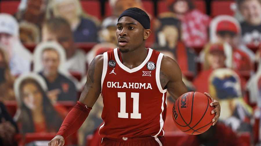 Oklahoma's De'Vion Harmon (11) dribbles the ball during the first half of an NCAA college basketball game against Texas Tech, Monday, Feb. 1, 2021, in Lubbock, Texas. (AP Photo/Brad Tollefson)