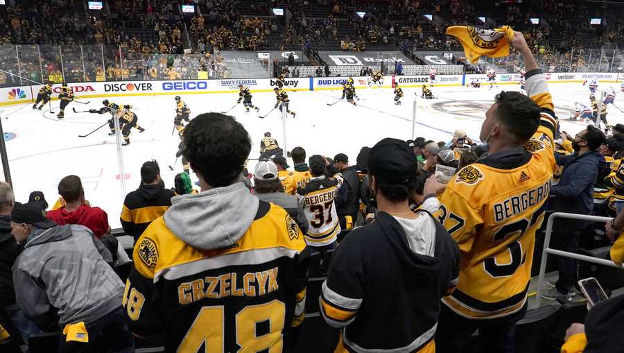 A full capacity crowd watch Boston Bruins players warm up for Game 1 of an NHL hockey second-round playoff series against the New York Islanders, Saturday, May 29, 2021, in Boston. (AP Photo)