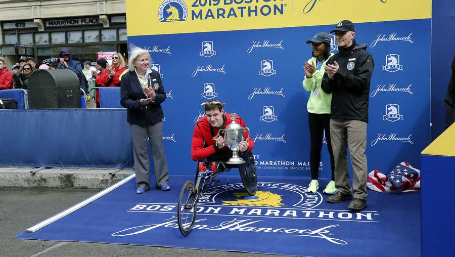Daniel Romanchuk, of Urbana, Ill., holds the trophy after winning the men's handcycle division of the 123rd Boston Marathon on Monday, April 15, 2019, in Boston. (AP Photo/Winslow Townson)