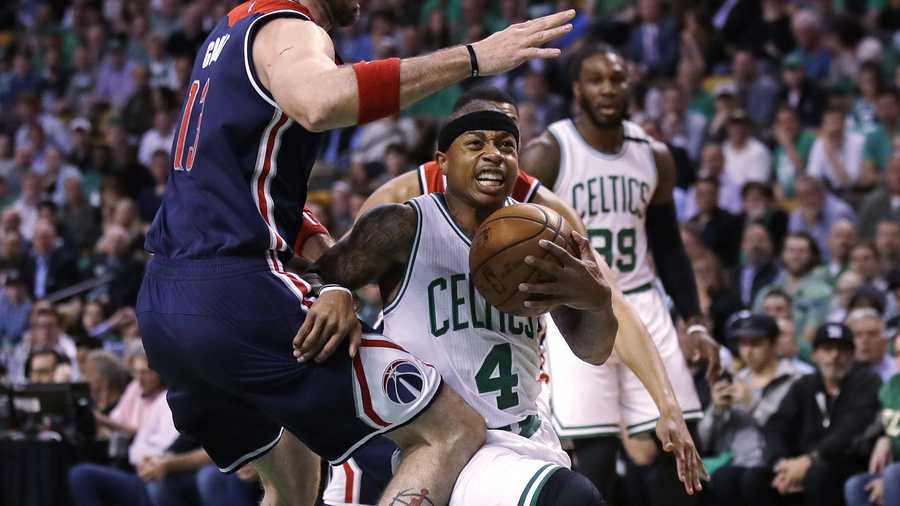 Boston Celtics guard Isaiah Thomas (4) drives to the basket against Washington Wizards center Marcin Gortat, left, during the first quarter of a second-round NBA playoff series basketball game in Boston, Tuesday, May 2, 2017.