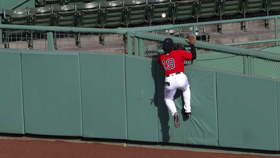 Boston Red Sox center fielder Jackie Bradley Jr. cannot get to a home run by Toronto Blue Jays&apos; Travis Shaw during the second inning of the first game of a baseball doubleheader Friday, Sept. 4, 2020, at Fenway Park in Boston. (AP Photo/Winslow Townson)