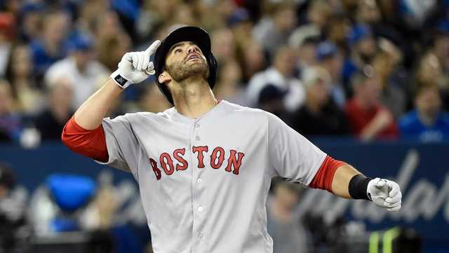 President Donald Trump is presented with a Boston Red Sox baseball team  jersey by Red Sox outfielder J. D. Martinez, during a ceremony on the South  Lawn of the White House in