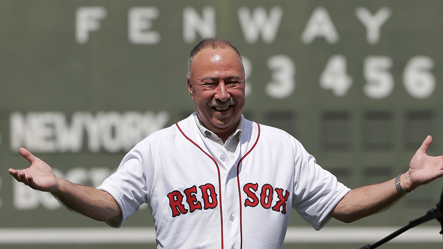 Boston Red Sox broadcaster Jerry Remy, left, is presented with a giant baseball glove by Boston Red Sox's Dustin Pedroia (15) during ceremonies held to celebrate Remy's 30 years in the broadcast booth at Fenway Park, before the start of a baseball game between the New York Yankees and the Red Sox, Sunday, Aug. 20, 2017 (AP Photo/Steven Senne)