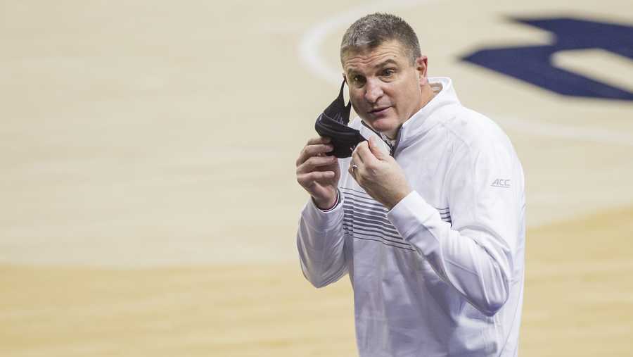 FILE - Boston College head coach Jim Christian calls to his bench as he fixes his face mask during an NCAA college basketball game against Notre Dame in South Bend, Ind., in this Saturday, Jan. 16, 2021, file photo. Notre Dame won 80-70. Boston College fired basketball coach Jim Christian on Monday, Feb. 15, 2021, with three weeks left in his seventh season. Assistant Scott Spinelli will serve as interim head coach for the rest of the season. (AP Photo/Robert Franklin, File)