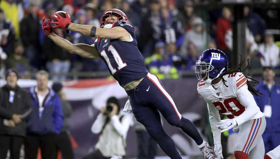 New England Patriots wide receiver Julian Edelman runs from