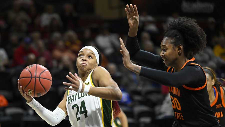 Baylor guard Sarah Andrews (24) drives for a basket against Oklahoma guard Sara Rodrigues (30) during the first half of an NCAA college basketball game in the Big 12 Conference tournament in Kansas City, Kan., Friday, March 11, 2022. (AP Photo/Reed Hoffmann)